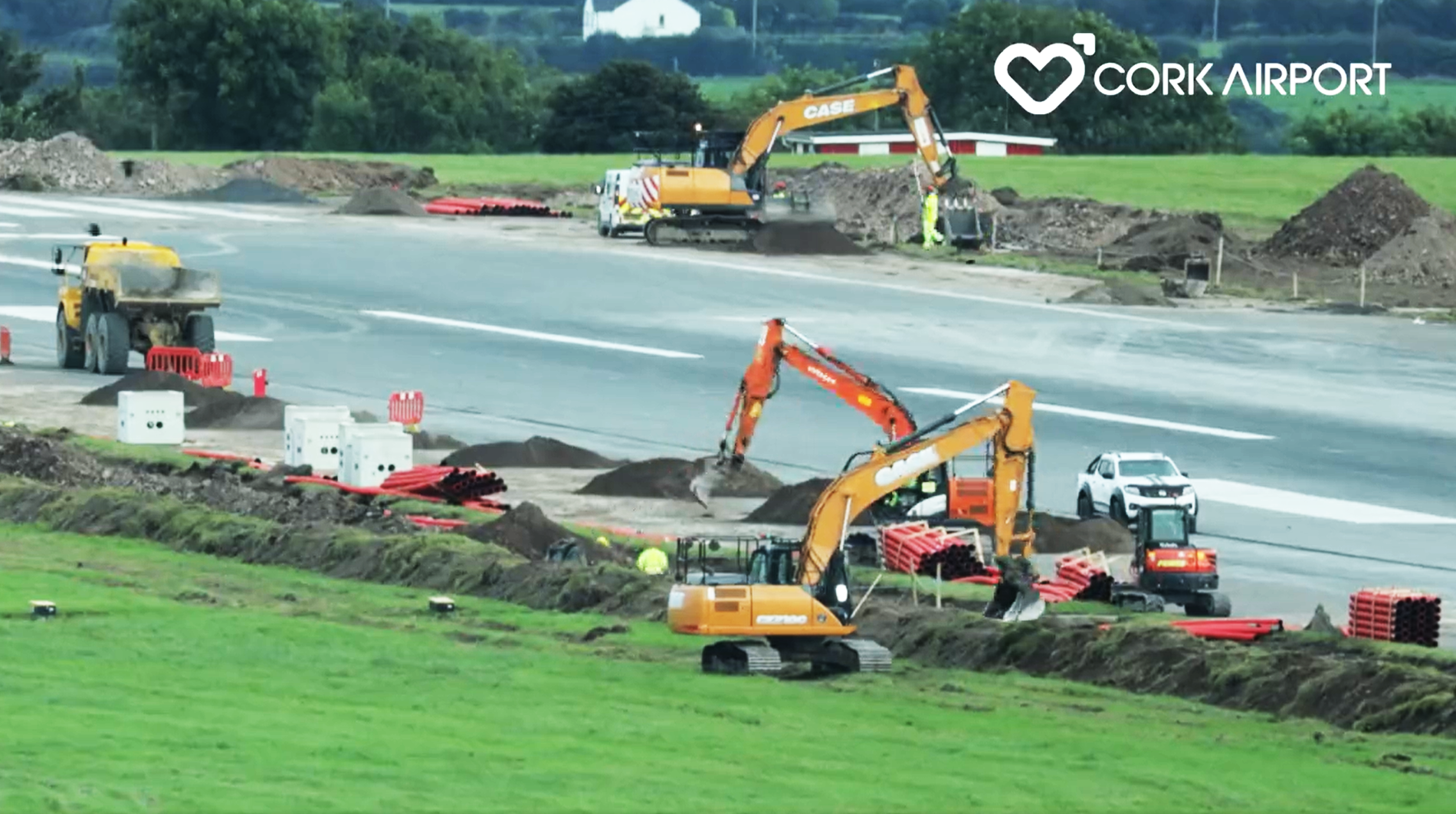 cork-airport-5 diggers installing pipework at the side of the runway at cork airport in ireland